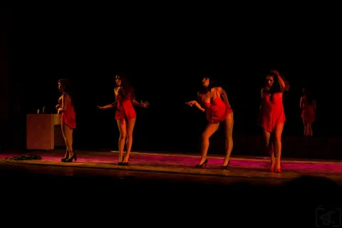 Barraca theater - four young dancers in striking red costumes take the stage.