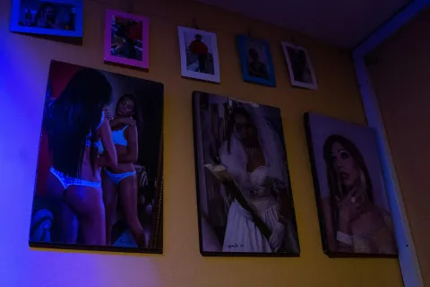 Museo Lgbti al interior fotografías colgadas en pared con cuerpos y rostros de personas trans. 