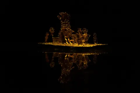 Gold Museum and the Muisca Raft or Golden Raft, a pre-Columbian goldwork piece made by the Muisca culture. On the raft appear simulated figures of the Chief adorned with headdresses, nose ornaments, and earrings, surrounded by his soldiers carrying banners.