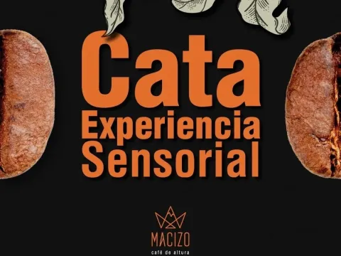 Un aviso fondo negro con letras grandes y naranjas que dice Cata Experencia Sesorial. Hay medio trozo de café en cada lado del aviso.