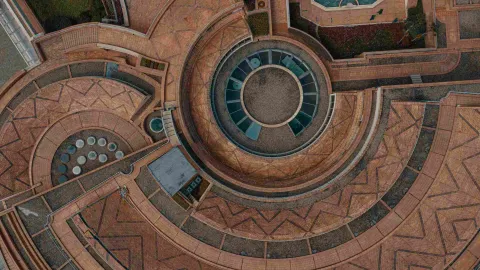 Brick structure with geometric shapes, particularly circles and ovals, seen from above.