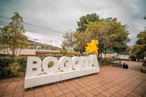 A large white sign with the word Bogotá, with yellow stars above the letter “A.”