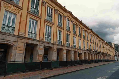 Plano general de la fachada exterior del palacio. Se observan muchas puertas en piedra en el primer piso y muchas ventanas en el segundo. 