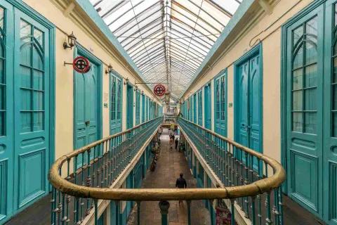 Floor plan of the second floor of an old building, showing several turquoise doors and gold handrails.