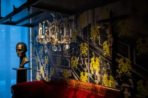 A red sofa and a chandelier in an elegant and inviting room.
