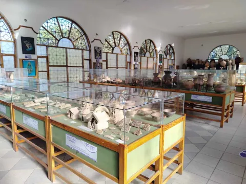 Un museo con numerosas vitrinas de vidrio llenas de diversos artefactos históricos.