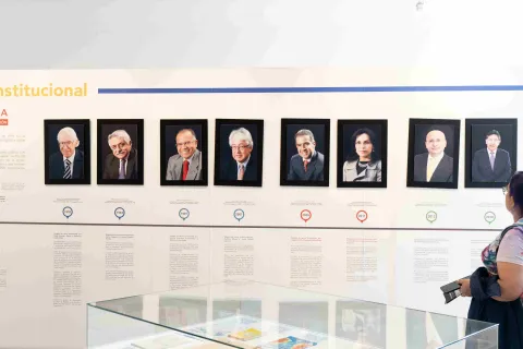 A museum exhibit presenting an institutional timeline with portraits of former officials and historical documents.
