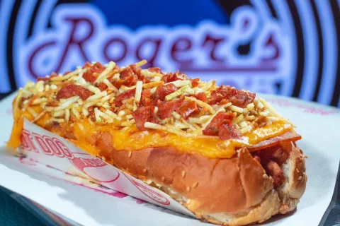 Pan con carne, queso fundido, tocineta y abundantes papas crocantes, una propuesta contundente de Roger’s 50’s.