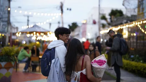 A couple walks through the San Felipe Art District at sunset, surrounded by open-air terraces, warm lights, and the neighborhood’s vibrant cultural and culinary scene.