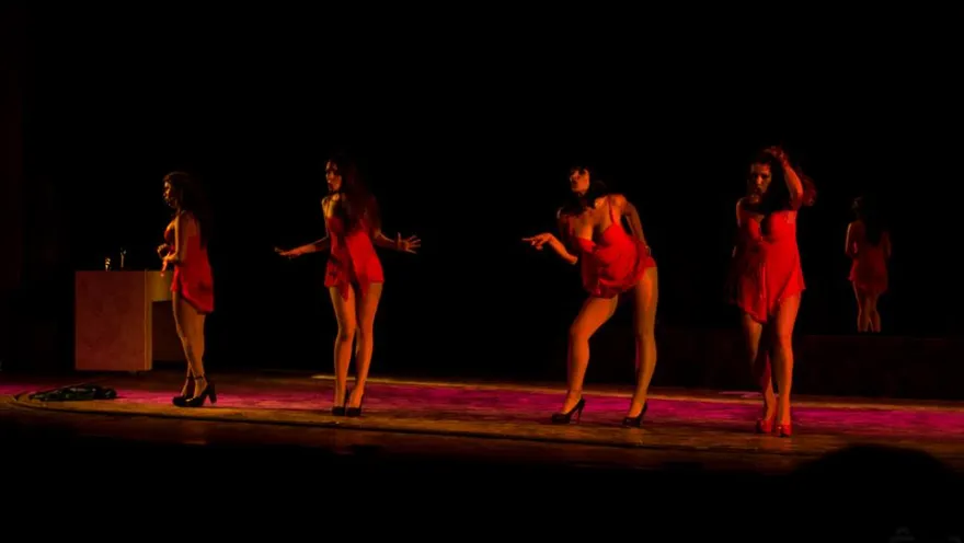 Barraca theater - four young dancers in striking red costumes take the stage.