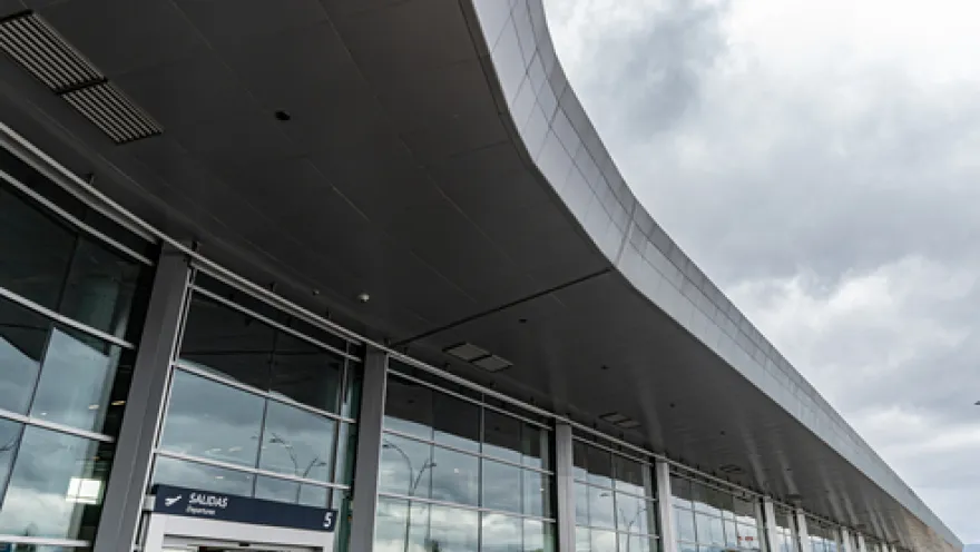 Exterior of a building with many windows on its first floor. There is a sign in white letters that reads ""Exit 5"".