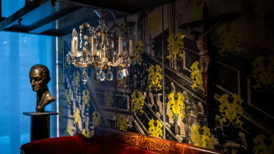 A red sofa and a chandelier in an elegant and inviting room.