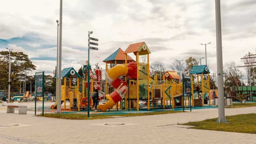 A children's playground with a colorful slide and a set of play equipment.