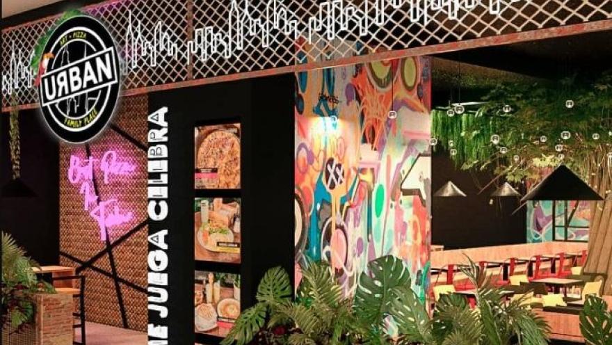 Facade of an “URBAN” store with a modern design, colorful graffiti, neon lighting, and a view of the interior with tables and tropical decor.