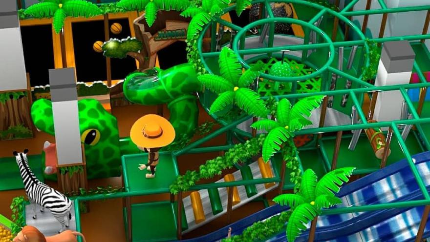 Jungle-themed children's play area with slides, green structures, decorative palm trees, and animal figures such as a lion, zebra, and snake.