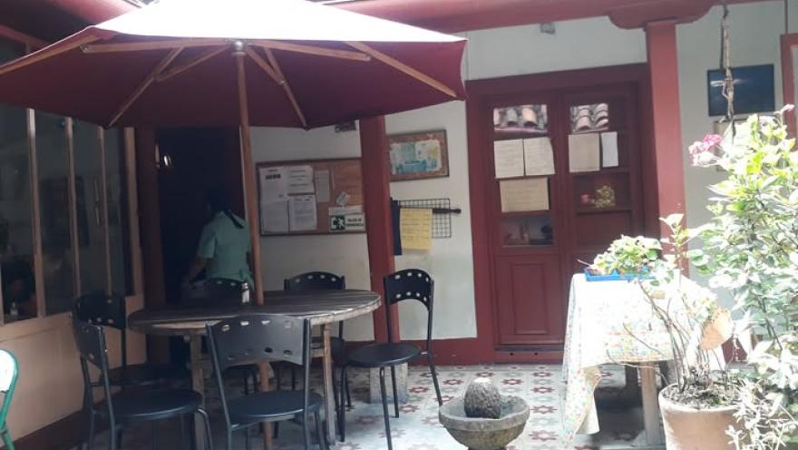 Interior patio of a traditional restaurant, featuring outdoor seating and colorful decor.