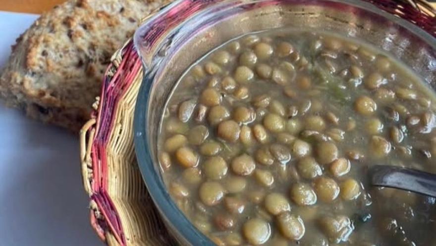 Lentil soup accompanied by artisanal bread.