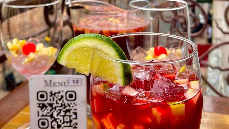 Glasses of sangria with fruits and lemon, served on a table at La Puerta de la Catedral.