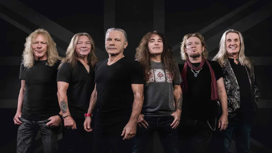 Los seis integrantes masculinos de la banda de Metal Iron Maiden en un fondo negro