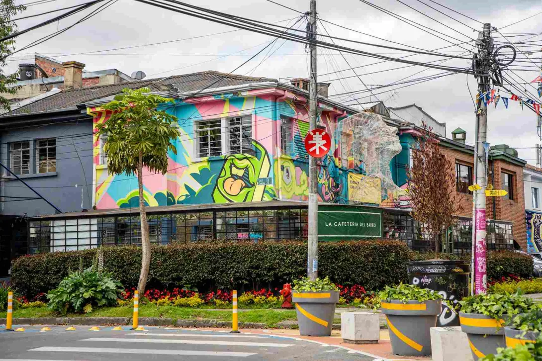 A street in the San Felipe Art District, where urban street art transforms building facades alongside cozy cafés, landscaped gardens, and the neighborhood's traditional architecture.